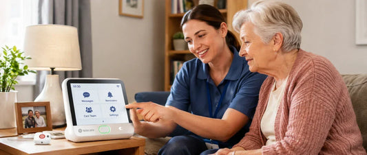 Carer showing an older woman how to use a telecare hub at home